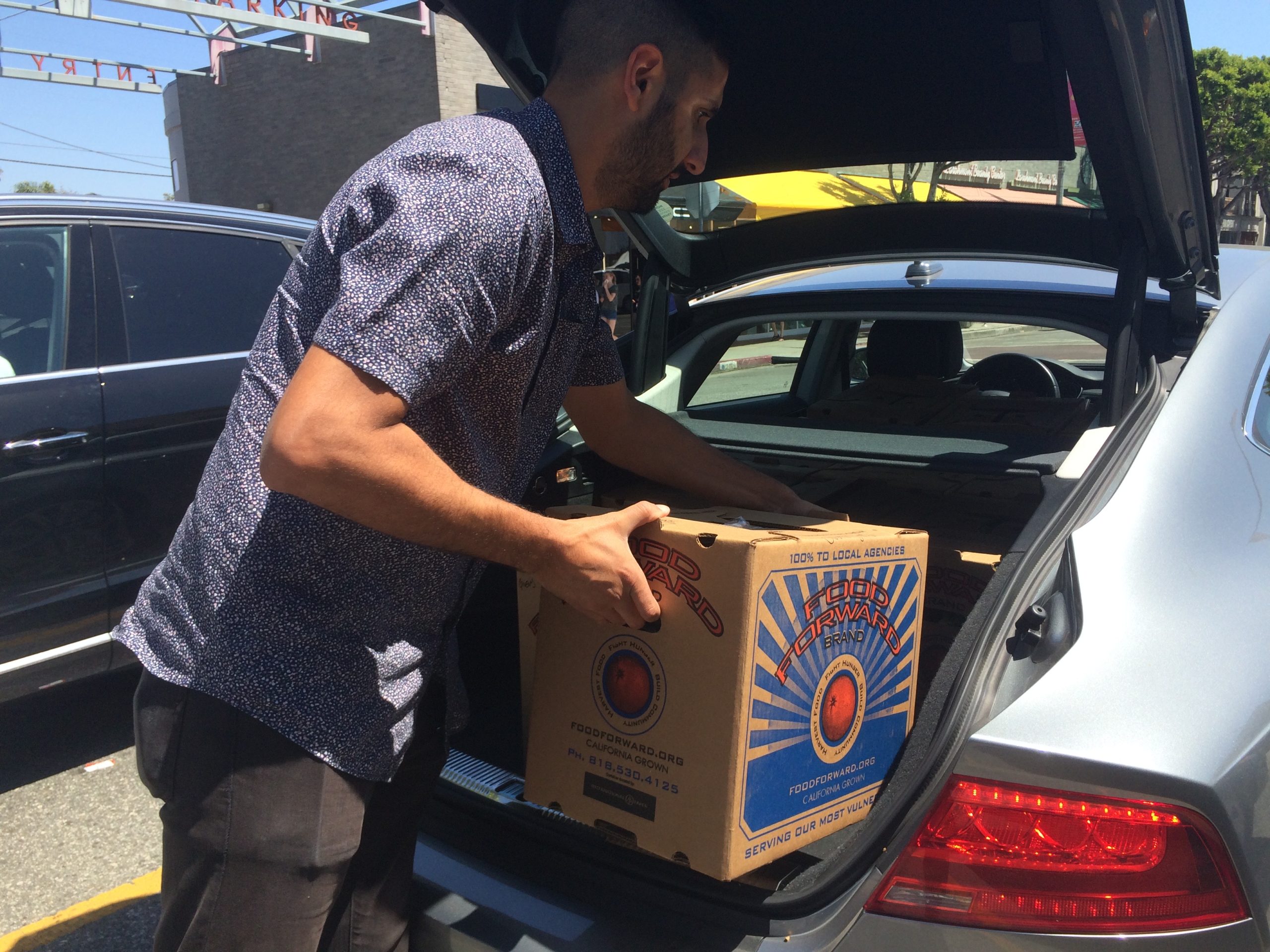 A Volunteer from PATH picks up the donation at the Larchmont Farmers Market