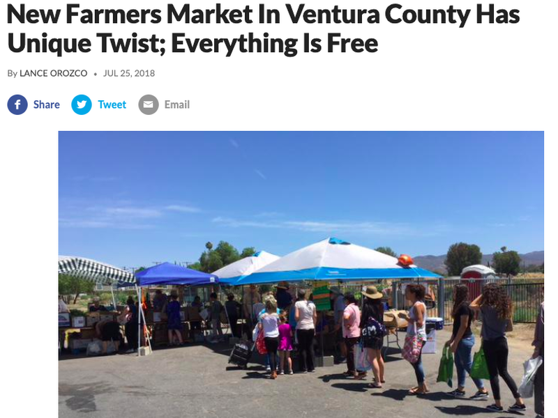 Screenshot of news headline with cover photo of people in line to receive free produce