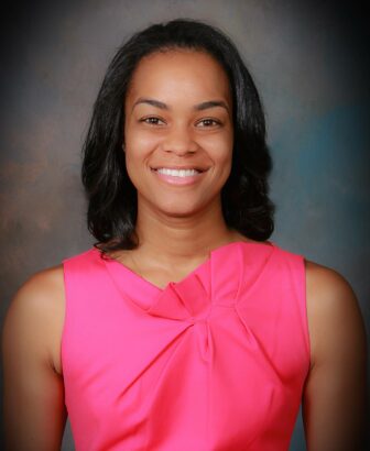 Erica Dent smiling in pink blouse