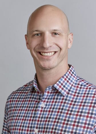 Jason smiling in checkered shirt