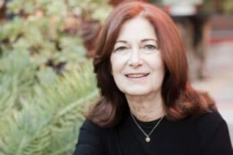 Shari smiling in front of greenery