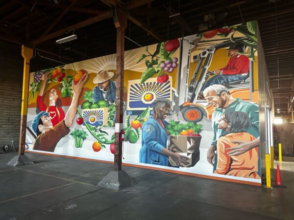Share The Abundance™ mural at the Pit Stop - mural with colorful images of people growing and distributing produce