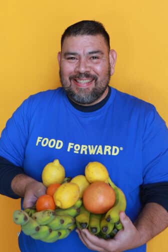 David holding a handful of fruit