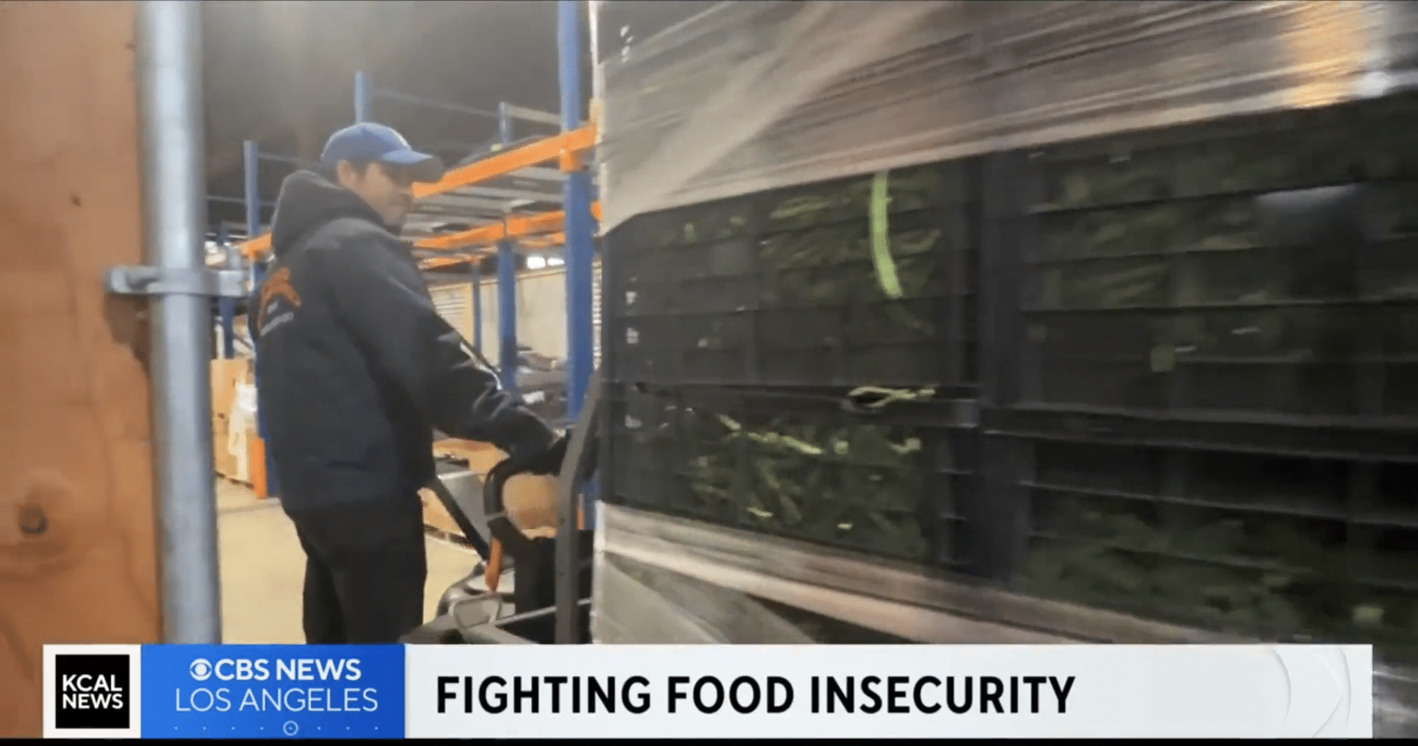 screenshot from CBS news featuring text reading Fighting Food Insecurity and Jorge on a pallet jack